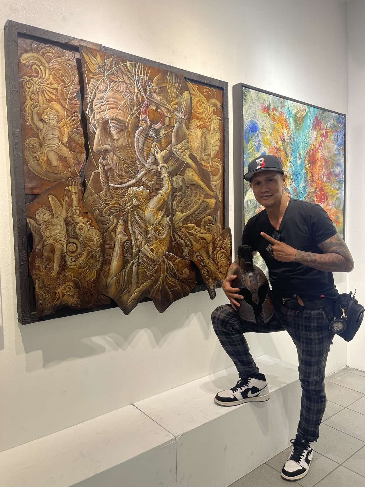 Acidhead beside a finished carved leather relief in gallery